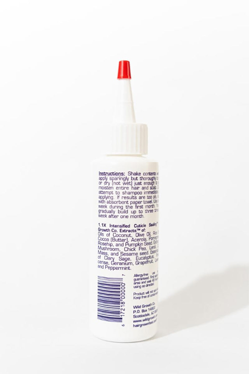 Never Before Now Growth Hair Oil 188 ml, von hinten gesehen, mit weißer Flasche und roter Spitze, Textetikett mit Inhaltsstoffen und Gebrauchsanweisung.