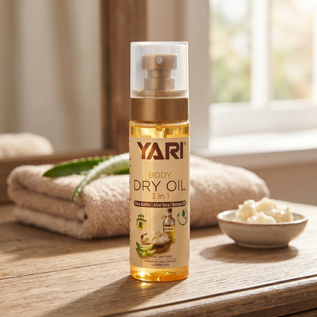 Yari Body Dry Oil 3 in 1 mit Sheabutter und Aloe Vera auf einem Holztisch neben dem Handtuch und Fenster.